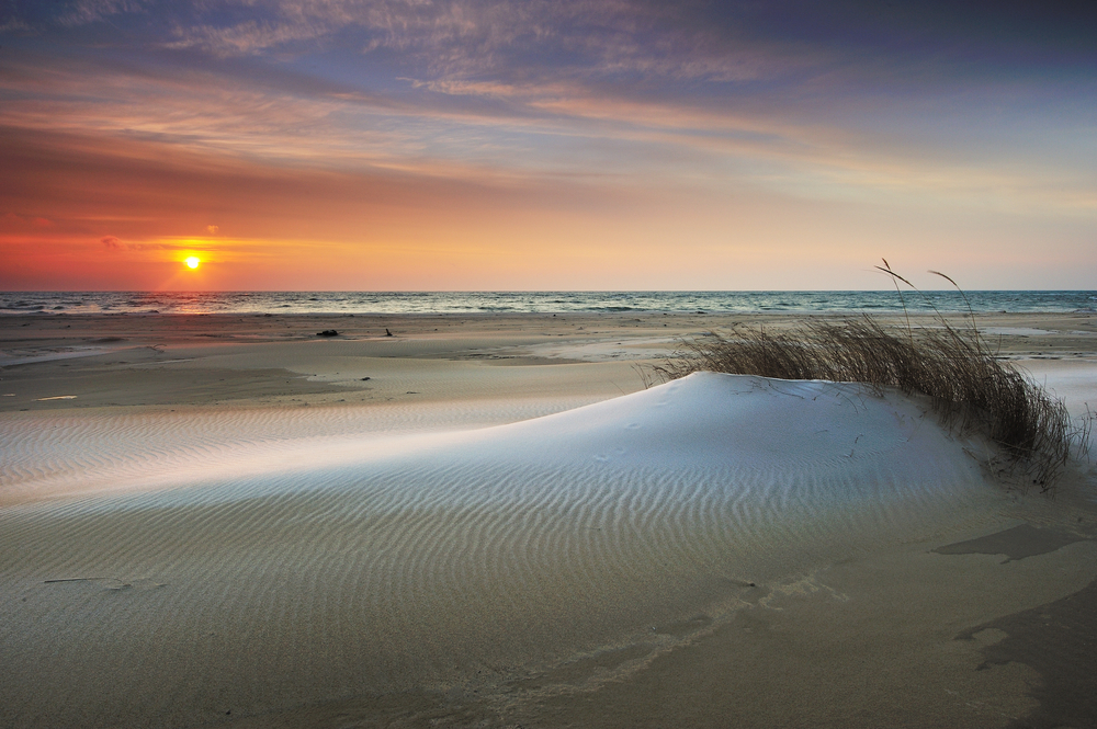 Tawas Beach with gorgeous sandy beach with sea oats and sunset in background. 