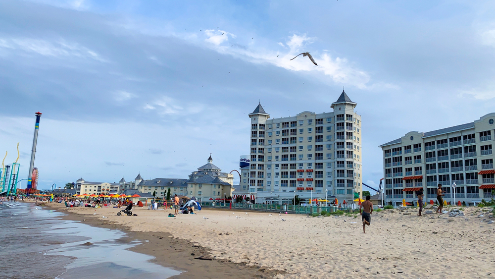 White sandy beach in Ohio with Cedar Point Hotels in background.