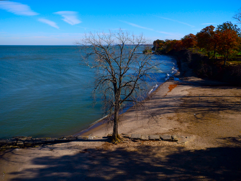 Ohio beach with sandy shoreline  with lake water lapping on shore.