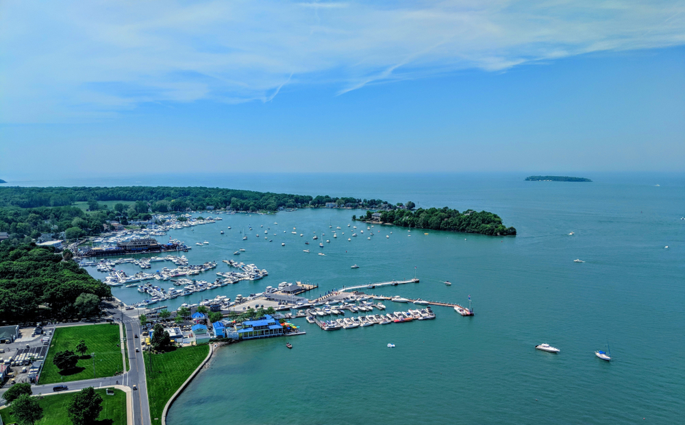 Aerial view of South Bass Island State park, with marina and deep blue-green Lake Erie waters.