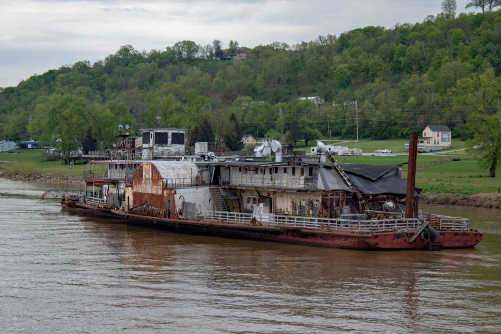 Rusting and dilapidated dredge boat on the Ohio River, one of the haunted places in Ohio.