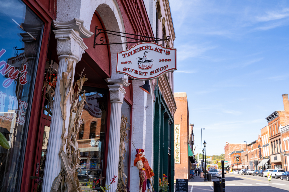 Cute shops along historic  downtown main street with vintage downtown buildings in background.