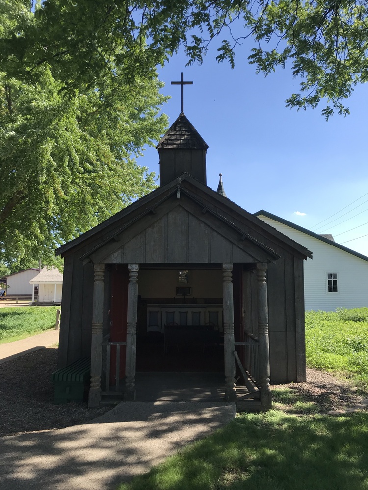 Brown wooden church with steeple Minnesota town.