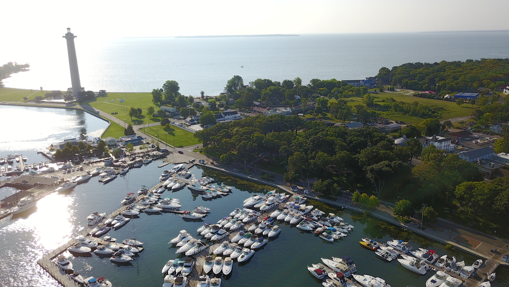 Overhead views of Put in Bay with marina, park and Perry Monument in the photo with Lake Erie in background.