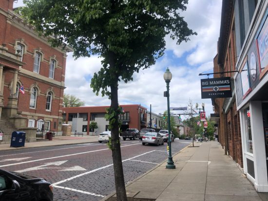 Vintage Main Street in Athens Ohio with cobblestoned street and Victorian-inspired lampposts.