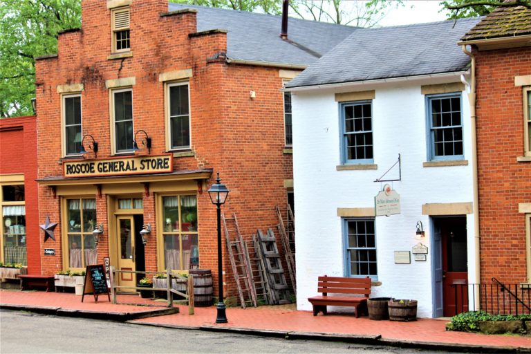 Historic brick building and next door white building in Coshocton an Ohio small town.