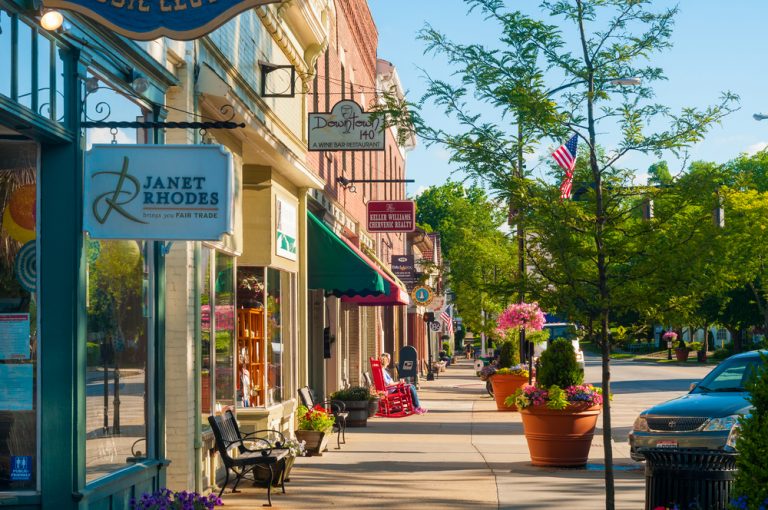 Pastel storefronts of downtown Hudson,  with flowering baskets everywhere. Small Town Ohio.