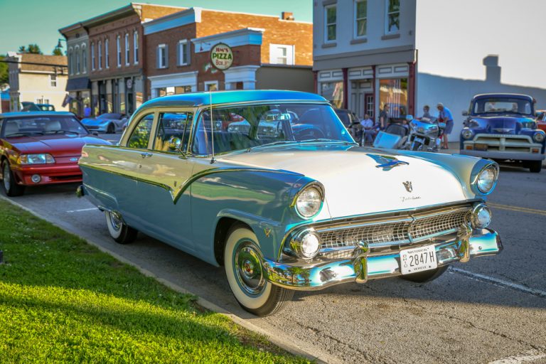 Downtown of small town Ohio Milan, with vintage teal blue car in foreground.