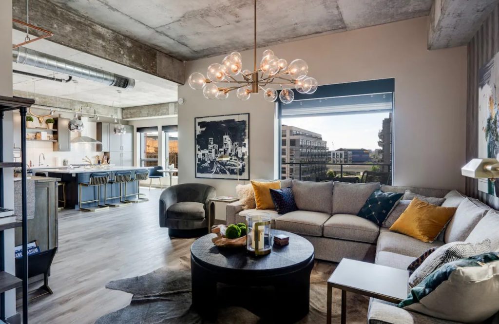 The main living space of a large modern loft with large picture windows that look out at the skyline of Minneapolis one of the best Airbnbs in the Midwest
