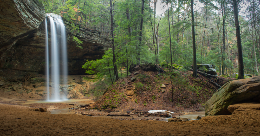 Visiting epic waterfalls like this one over the shale stones of Hocking Hills is one of the best things to do in Ohio.