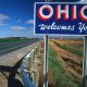 Blue Ohio Welcomes You sign alongside highway