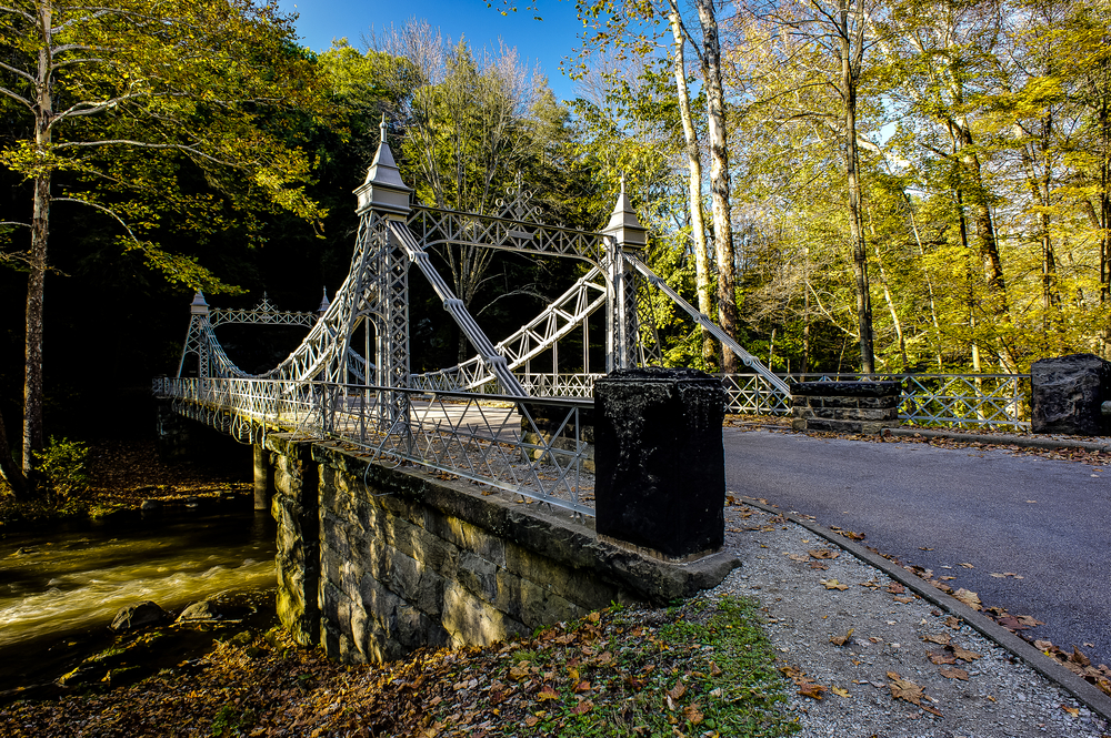 Ornate silver suspension bridge over creek in Youngstown Ohio.