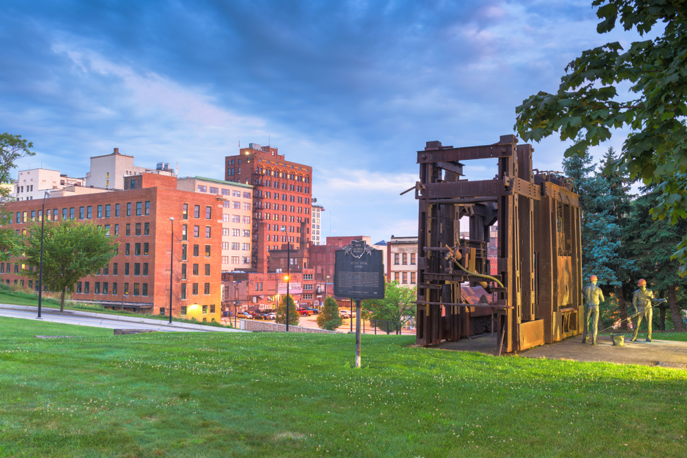 Little Steel Mill Workers Monument and Memorial with Youngstown Ohio downtown building in background.