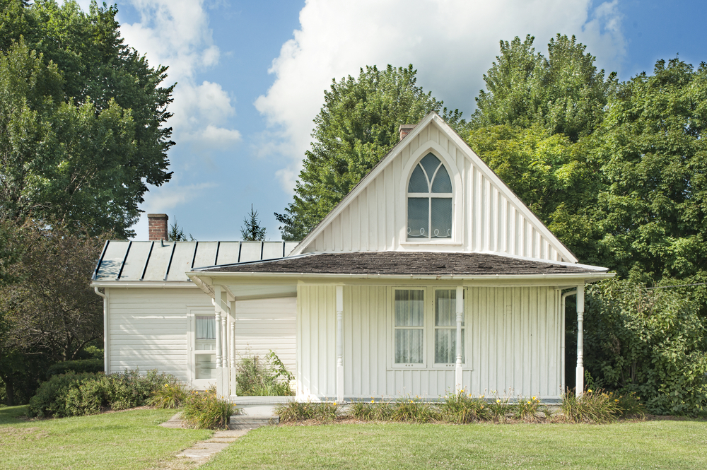 The original house that inspired the iconic painting 'American Gothic' in Iowa on a sunny summer day