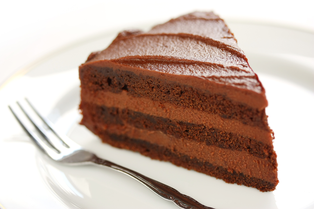 A slice of Old Fashioned Chocolate Cake on a white plate