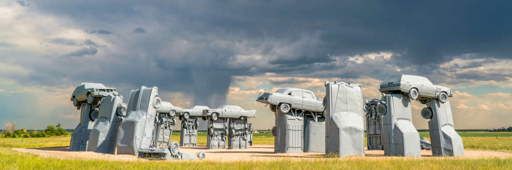 The Carhenge sculpture with a dramatic sky in the background in Nebraska