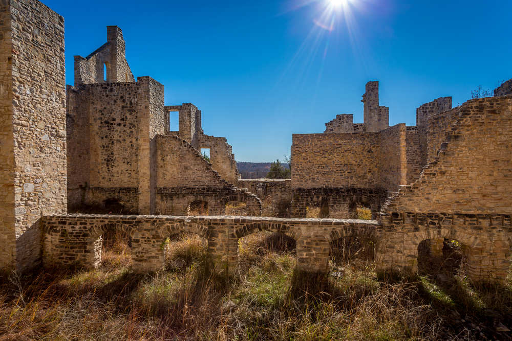 The Ha Ha Tonka Castle Ruins on a sunny day with the sun shinning directly on the ruins