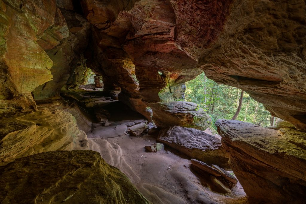 A cave with openings and columns in Hiking in Hocking Hills