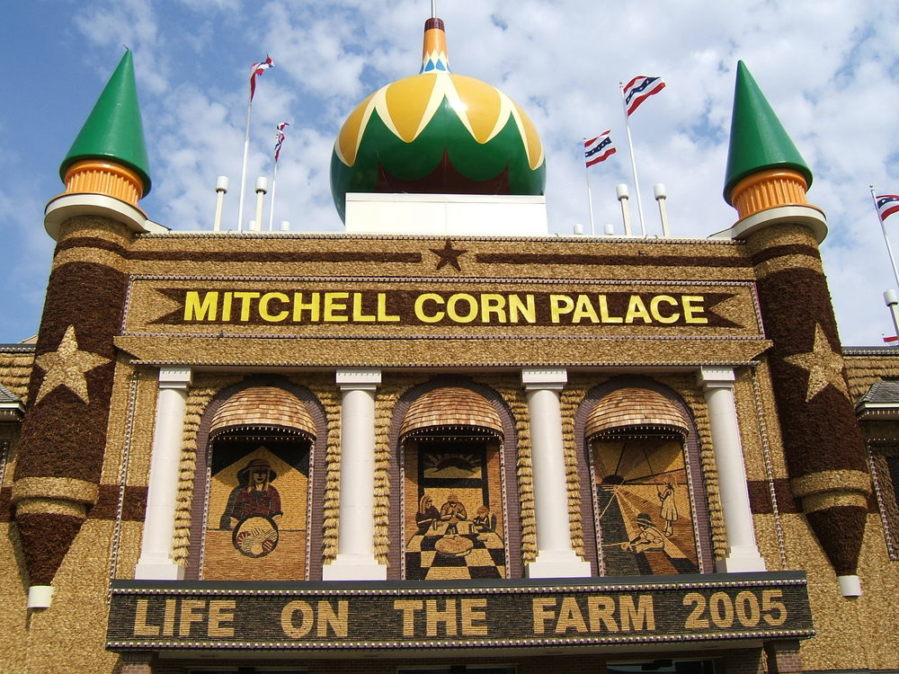 The exterior of the Mitchel Corn Palace on a sunny day with murals made of corn and other grains 