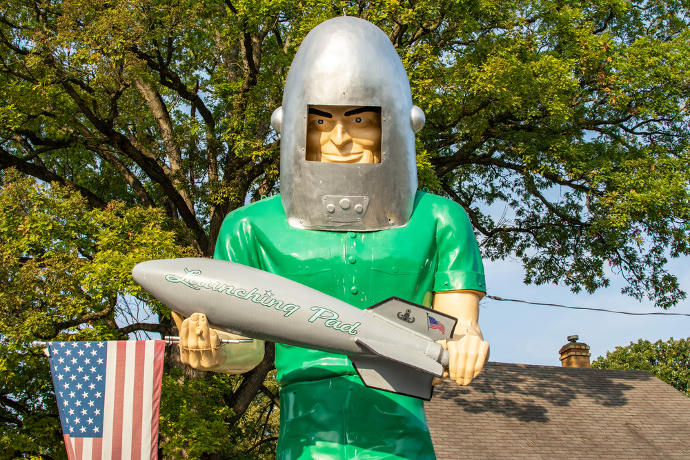 The green Gemini Giant statue, holding a silver rocket, a unique road side attraction in Illinois part of Midwest road trips.