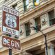 a sign in chicago marking the beginning of historic route 66 one of the best midwest road trips