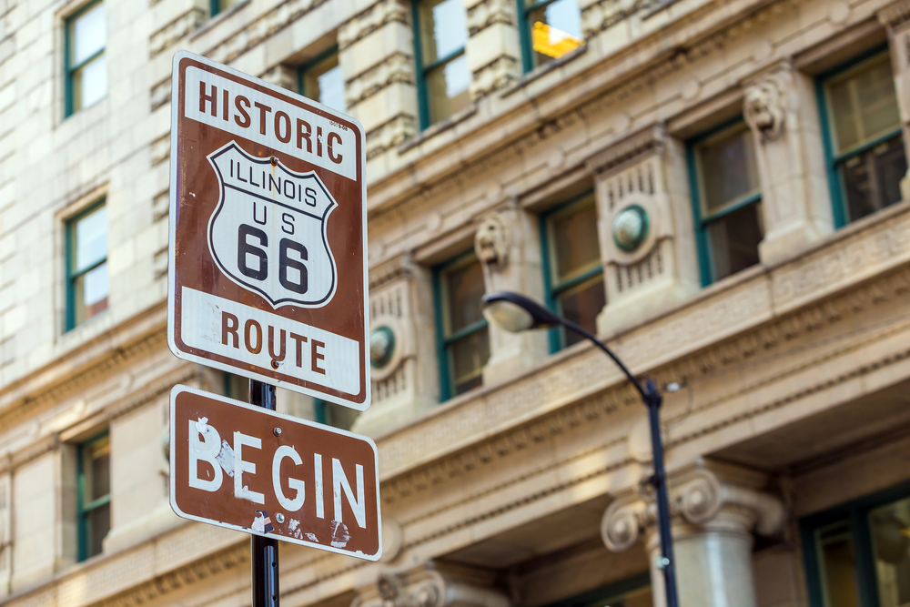 a sign in chicago marking the beginning of historic route 66 one of the best midwest road trips