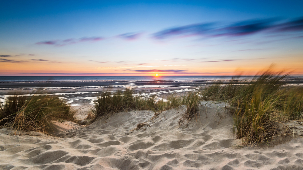 Sandy dunes at Sleeping Bear Dunes National Lakeshore one of the best national parks in Michigan at twilight looking out onto the lake