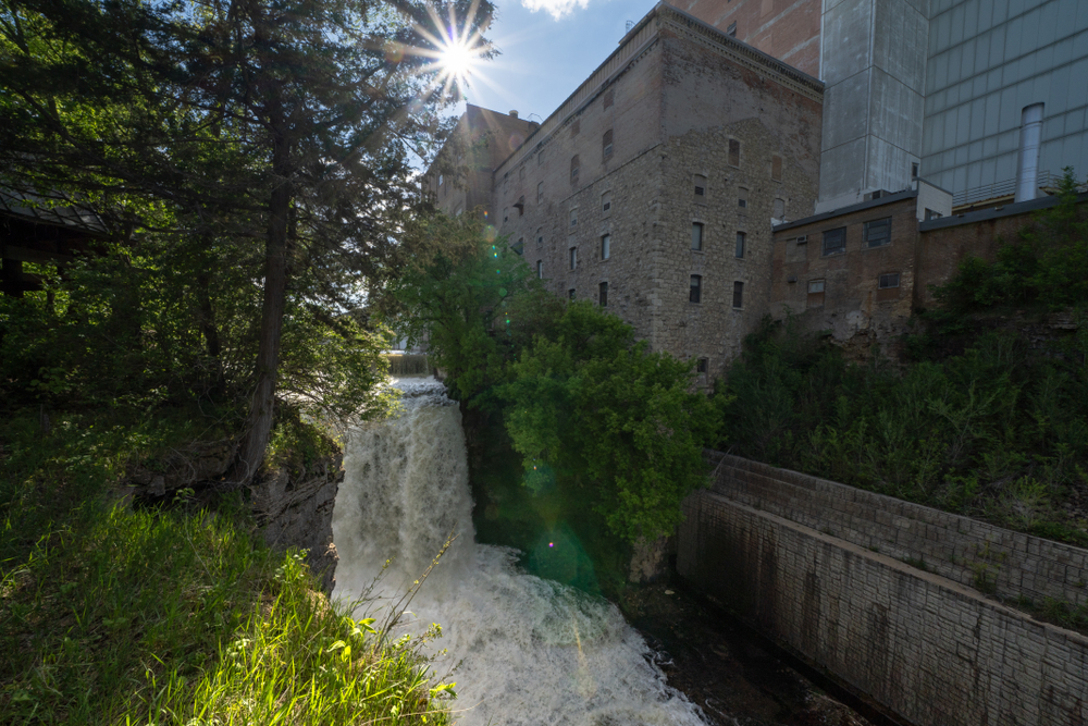 A large waterfall in the middle of a factory district in a city waterfalls in Minnesota