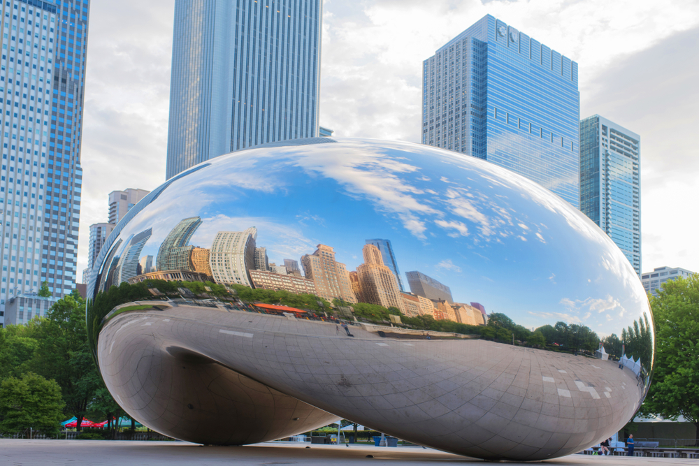 Large silver monument shaped like a bean with city skyscrapers reflected on its side during 2 days in Chicago.
