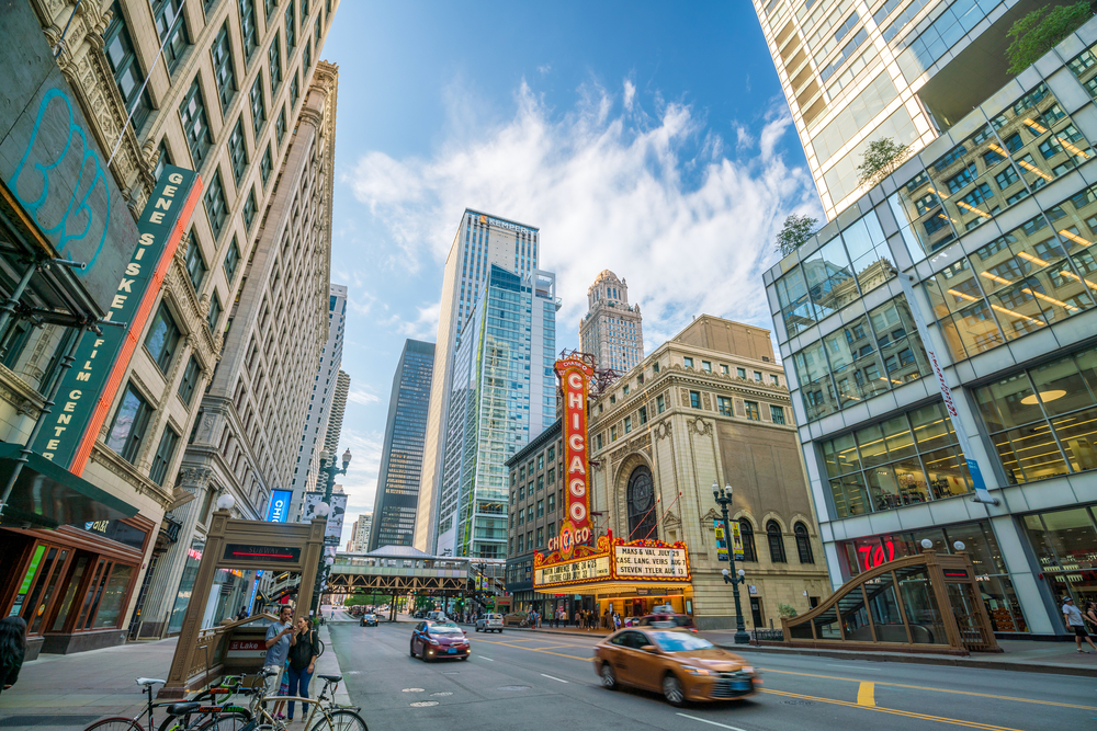 Busy Chicago downtown street with cars in road and iconic theater with CHICAGO spelled out in huge letters. 2 days in Chicago.