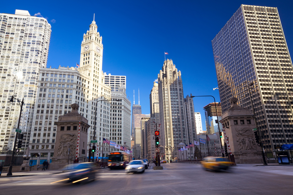 Blurred cars traveling through downtown street among lots of skyscrapers. 2 days in Chicago.