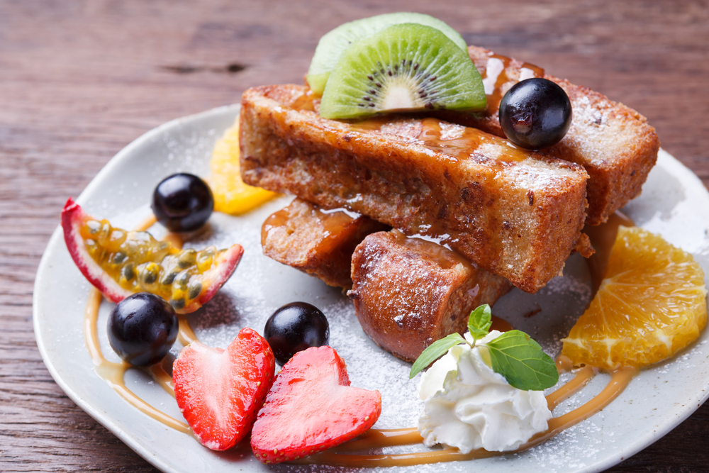 French toast on a plate with fresh fruit in an article about breakfast in Chicago