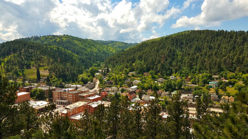 An aerial photo of Deadwood North Dakota nestled in the mountains in the background Cities in the Midwest