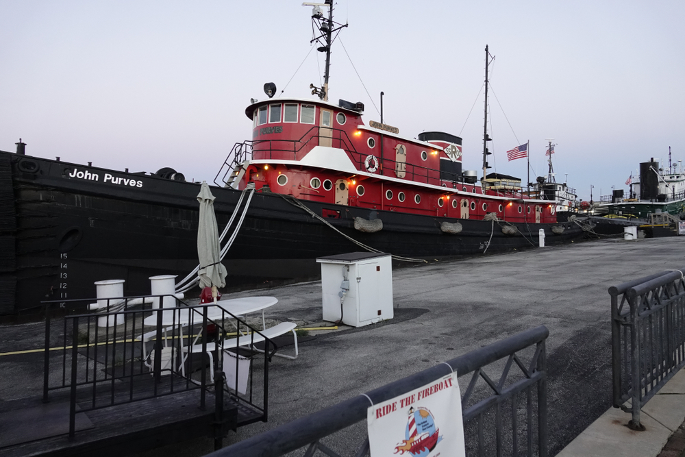 A red and black old tug boat in harbor in an article about things to do in Door County