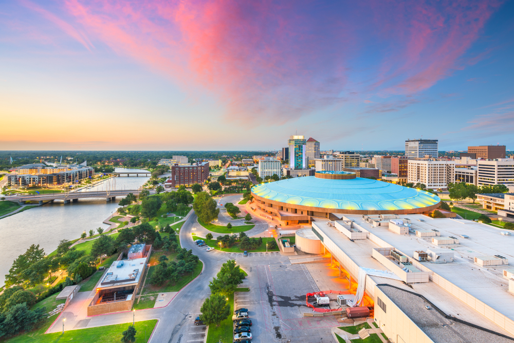 City next to river with stadium with large blue roof. cities in the midwest.