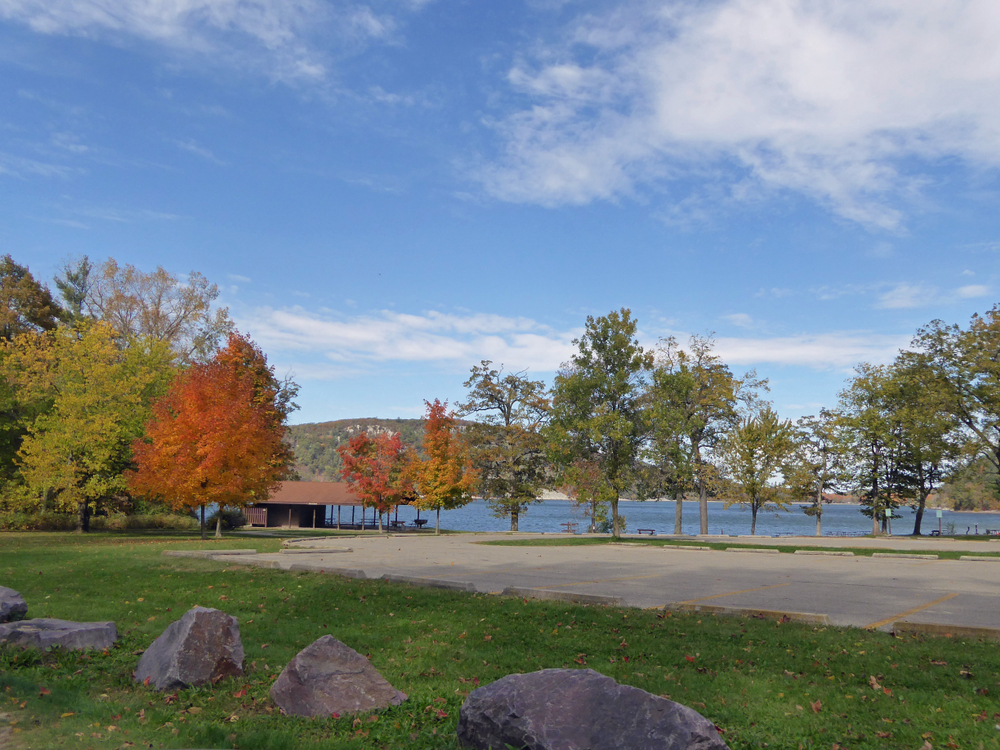 Trees in orange leaves of autumn around lake. Fall in Wisconsin.