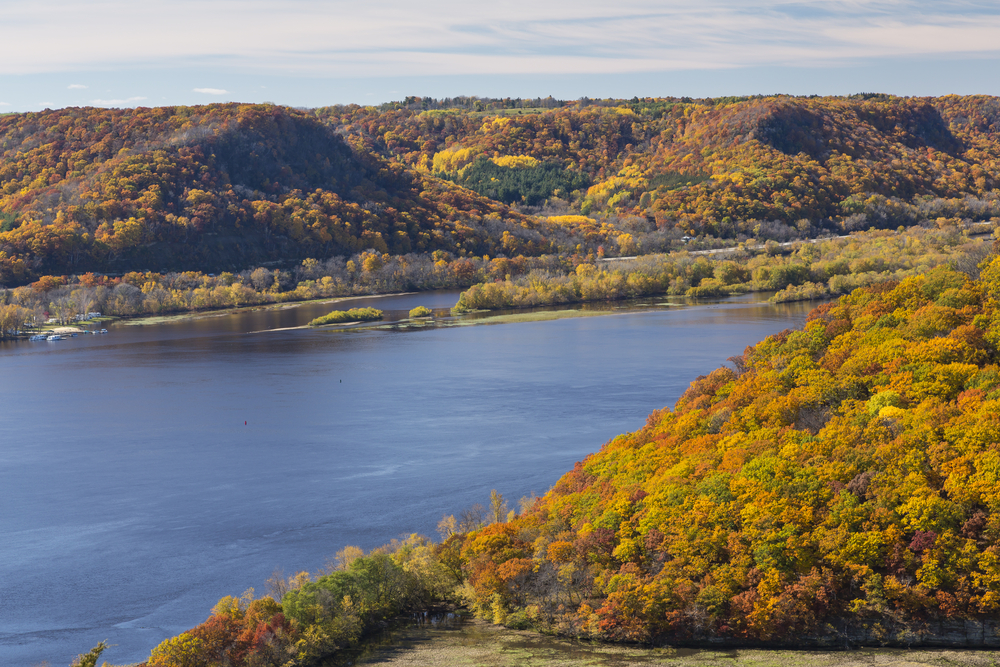 A lake with mountains covered in fall foliage