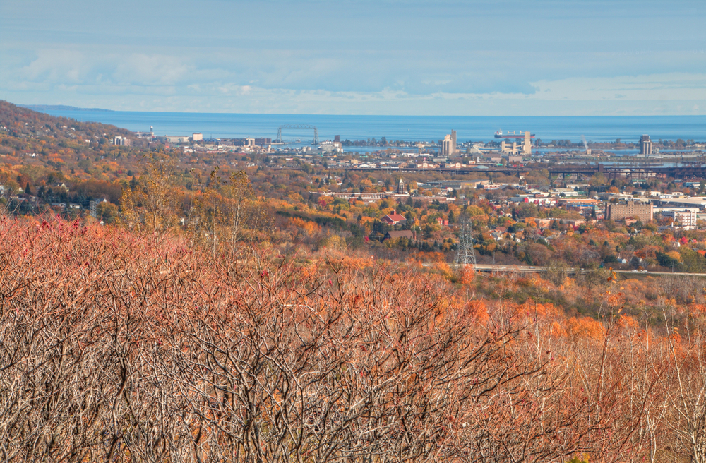 A view over Duluth town with foliage in the foreground in an article about things to do in Duluth