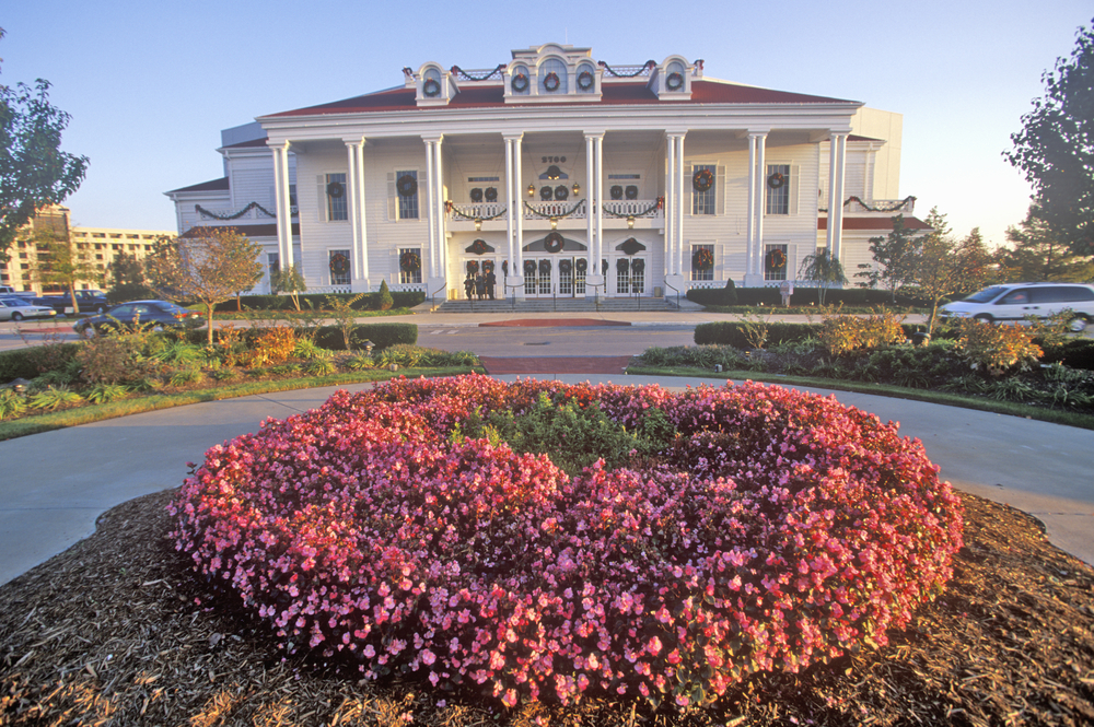 Things to do in Missouri include tall white building with white columns with flowers in foreground.