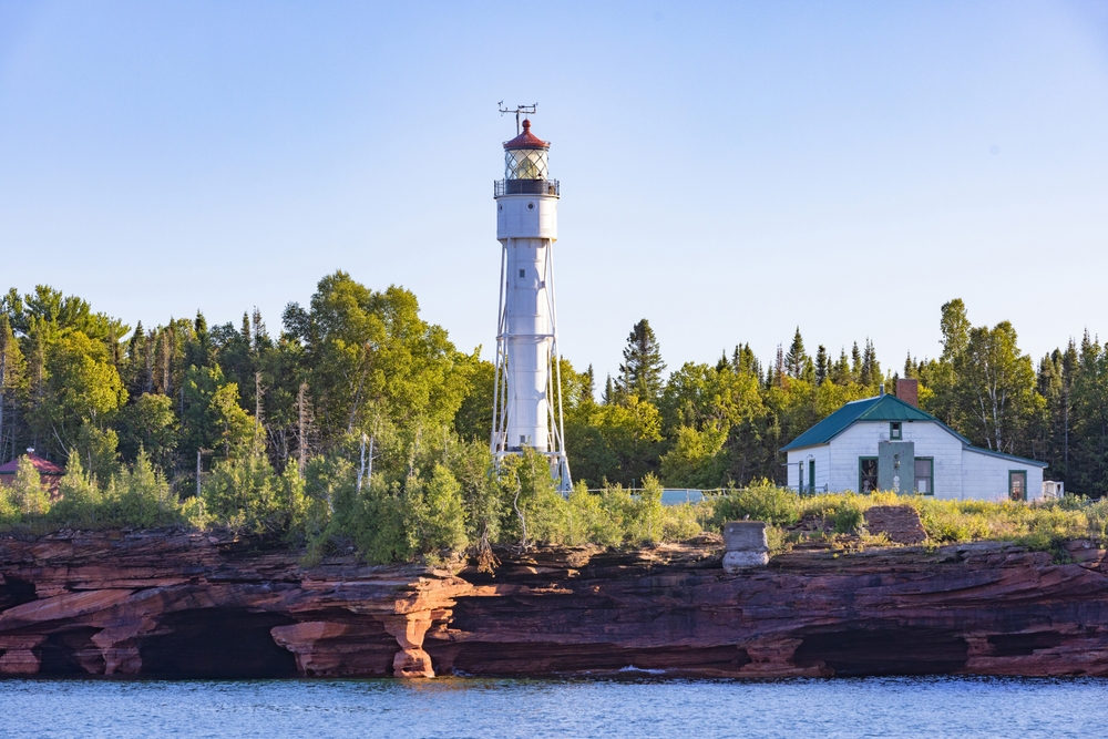 The sea caves of The Apostle Islands is home to this pretty lighthouse in Bayfield Wisconsin. The article is about the best Wisconsin weekend getaway.