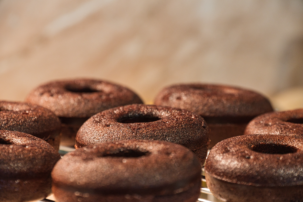 Chocolate vegan doughnuts on a cooling rack