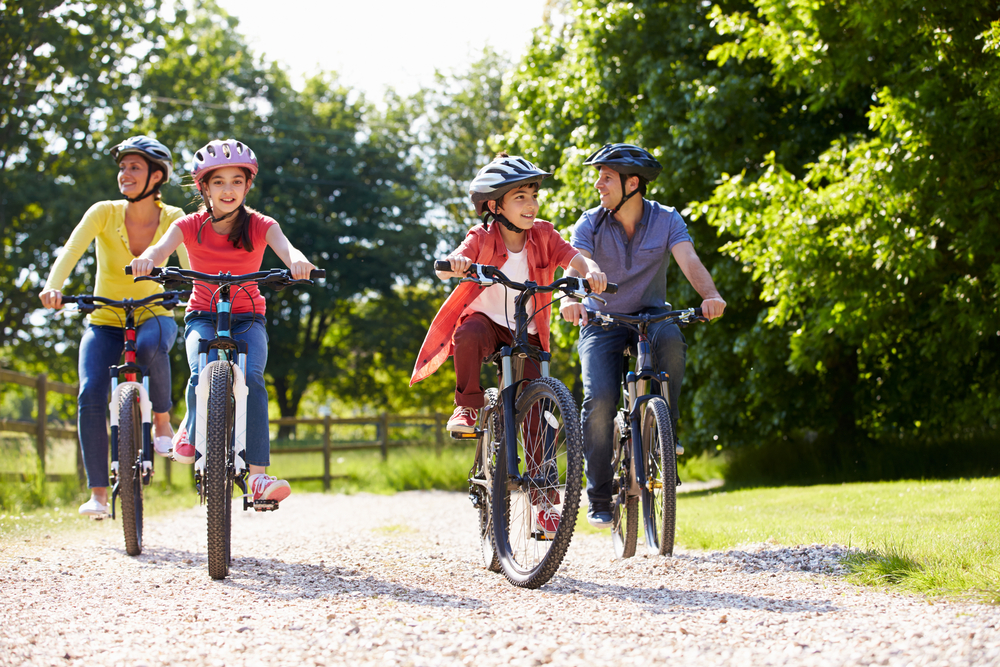 A family of four on a cycle ride in the countryside