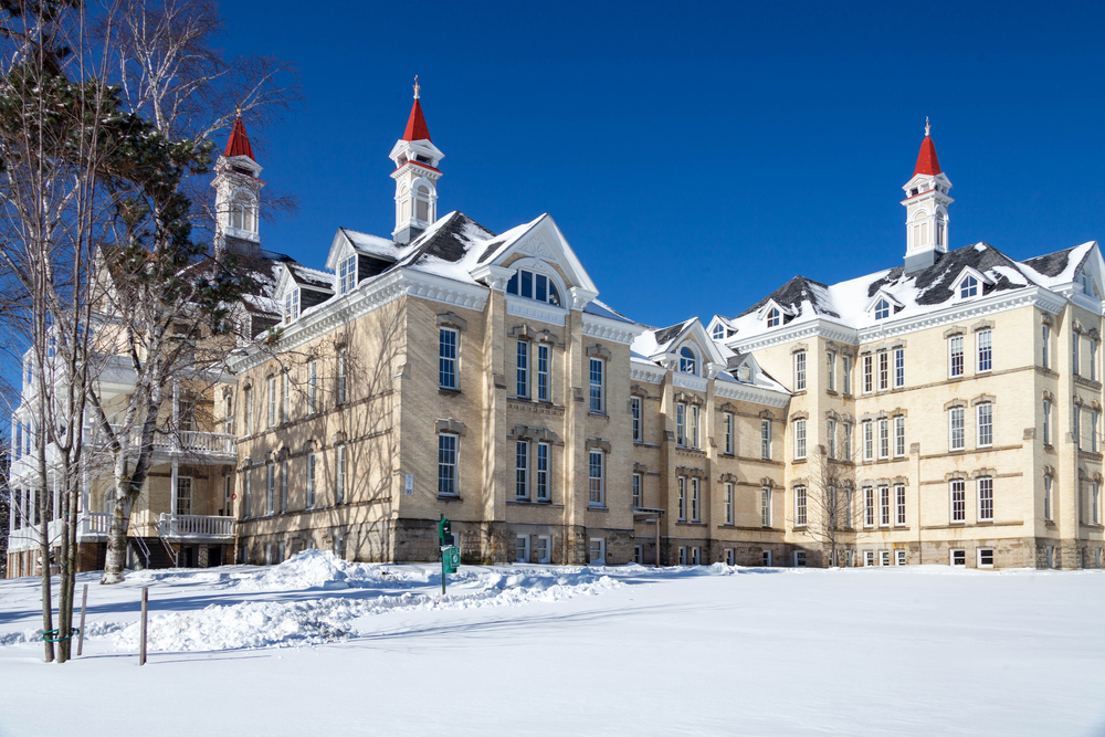 a beautiful cream building in the snow at The Village At Grand Traverse Commons one of the things to do in Traverse City