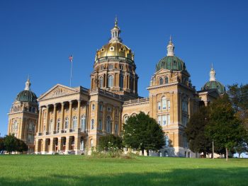 Large ornate capitol building with gold accents and domes. One of the interesting things to do in Iowa