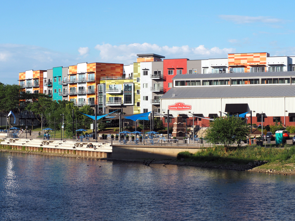 A river with buildings around the outside, the downtown is one of the things to do in Lansing