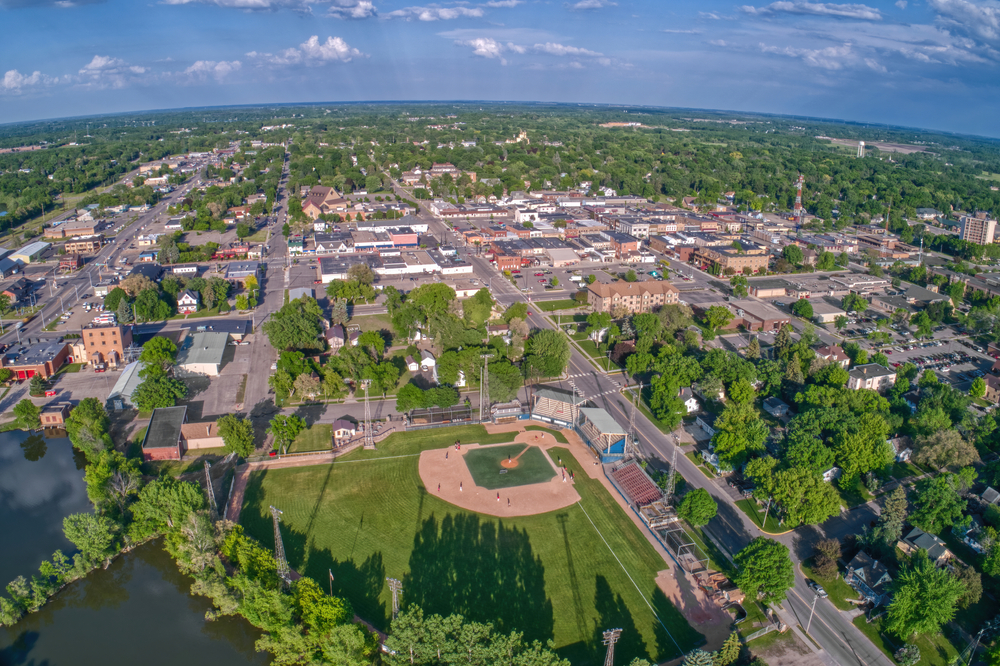 An aerial view of Alexandria Minnesota. You can see a baseball field, parks, buildings, and homes. There are large trees scattered throughout the city. One of the best things to do in Minnesota. 