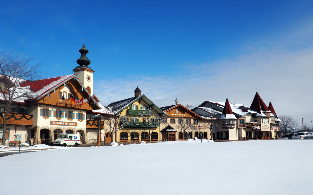 Bavarian-style shops in Frankenmuth covered in snow. This is a great place to go during Christmas in Michigan.