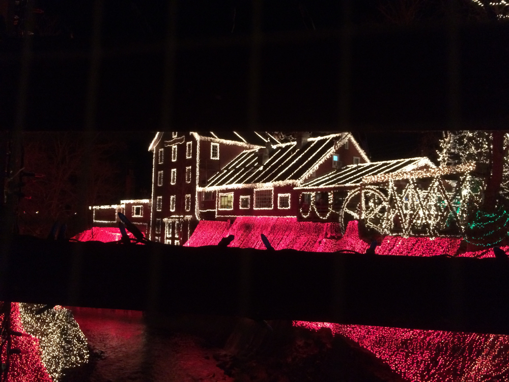 Large buildings connected illuminated with sparkly white lights.