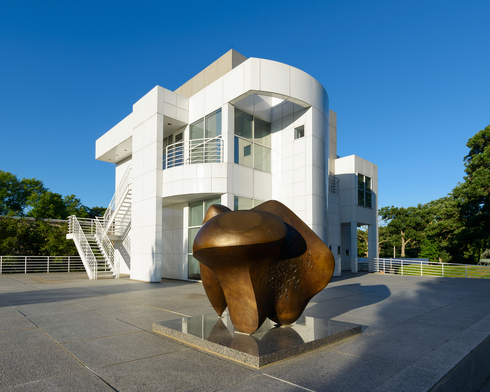 The outside of the Des Moines Art Center with an abstract sculpture in front.