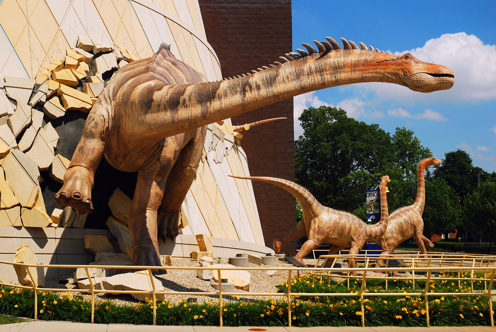 Dinosaur sculptures busting out of the Children’s Museum of Indianapolis, one of the coolest things to do in Indianapolis for families.